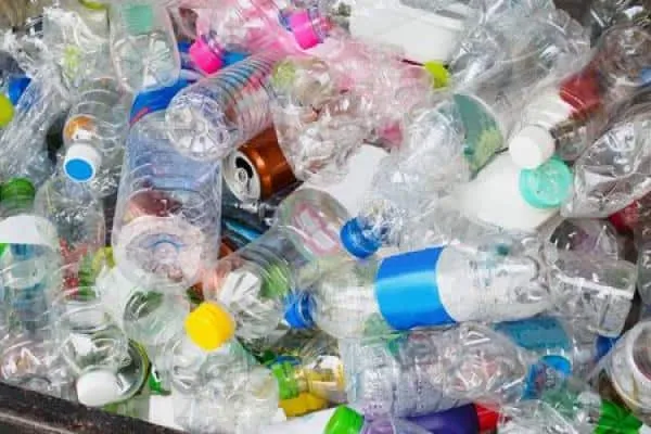 A recycling bin full of empty plastic bottles